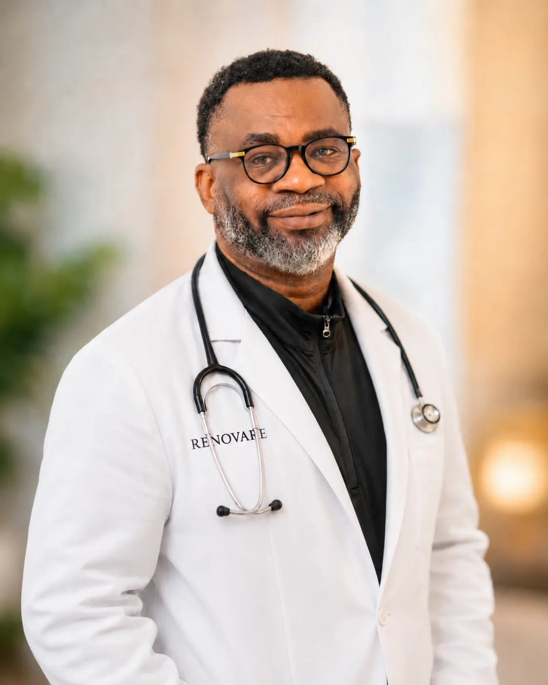 Portrait of Olumide Oluwole wearing a white coat and stethoscope